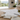 Detailed renovation floor plans with material samples and measuring tape on a table