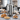 Coffee urn surrounded by plates of pastries on a catering table
