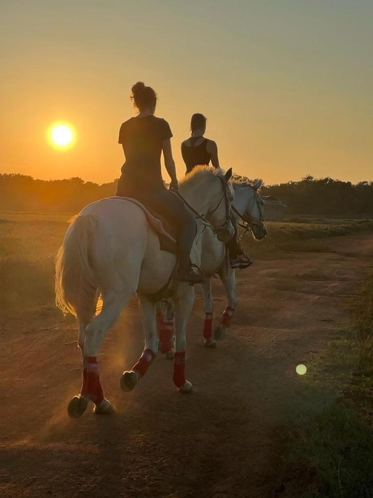 Riders on horseback during a sunset trail ride at Vonfidel Ranch in Sri Lanka