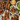 Grilled chicken skewers with fries and dipping sauces on a wooden table