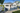 A house with a light wooden facade and a garage