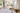 Detailed renovation floor plans with material samples and measuring tape on a table