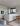 Minimalist white kitchen with island and wooden elements